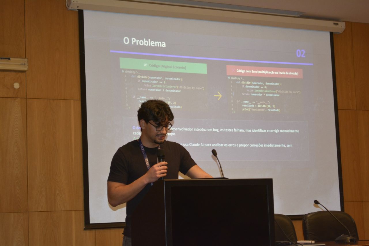 Enrico Nunes at a lectern presenting a slide about automatically fixing bugs with Claude AI